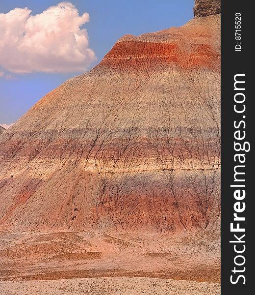 Bands of color appear across a large hill in the Painted Desert, Arizona. Bands of color appear across a large hill in the Painted Desert, Arizona