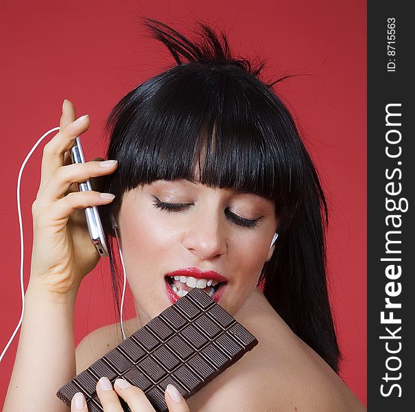 Sensual women who eat chocolate and listen to music