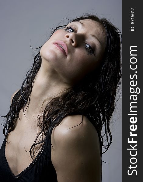 Beautiful wet brunette portrait in studio shot