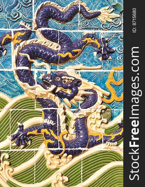 Traditional detail of a chinese ceramic dragon on the palace wall. Traditional detail of a chinese ceramic dragon on the palace wall.