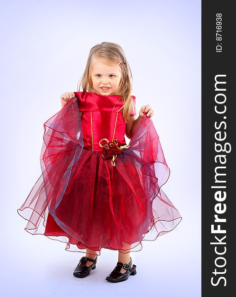 Portrait of the beautiful girl in a red dress