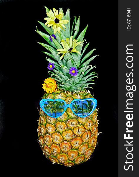 Whole pineapple with scenic reflection in sunglasses. Whole pineapple with scenic reflection in sunglasses.