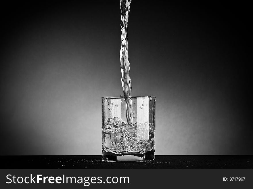 Water being poured into an empty glass. Water being poured into an empty glass