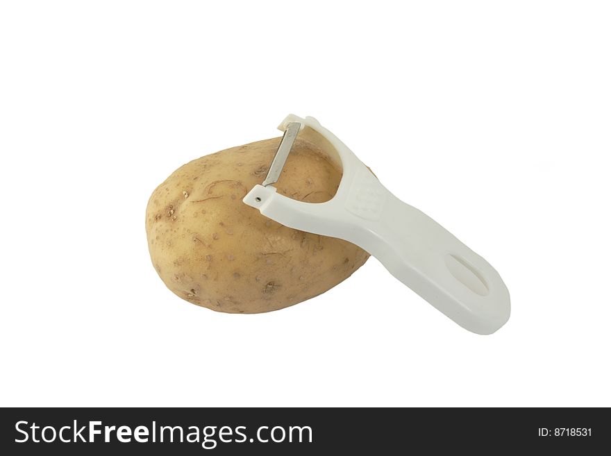 Image of a potato and peeler isolated on a white background. Image of a potato and peeler isolated on a white background