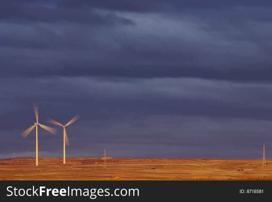 Windmills at dawn on a stormy