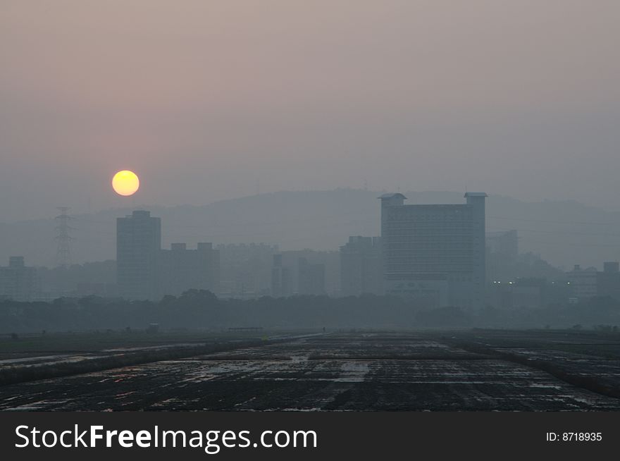 The Foggy City And Sunset