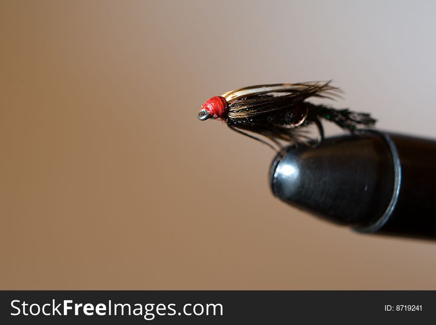 Fly fishing fly on the tying vise. Fly fishing fly on the tying vise
