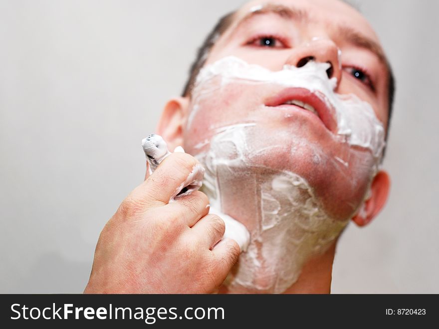 Man with razor against gray background. Man with razor against gray background