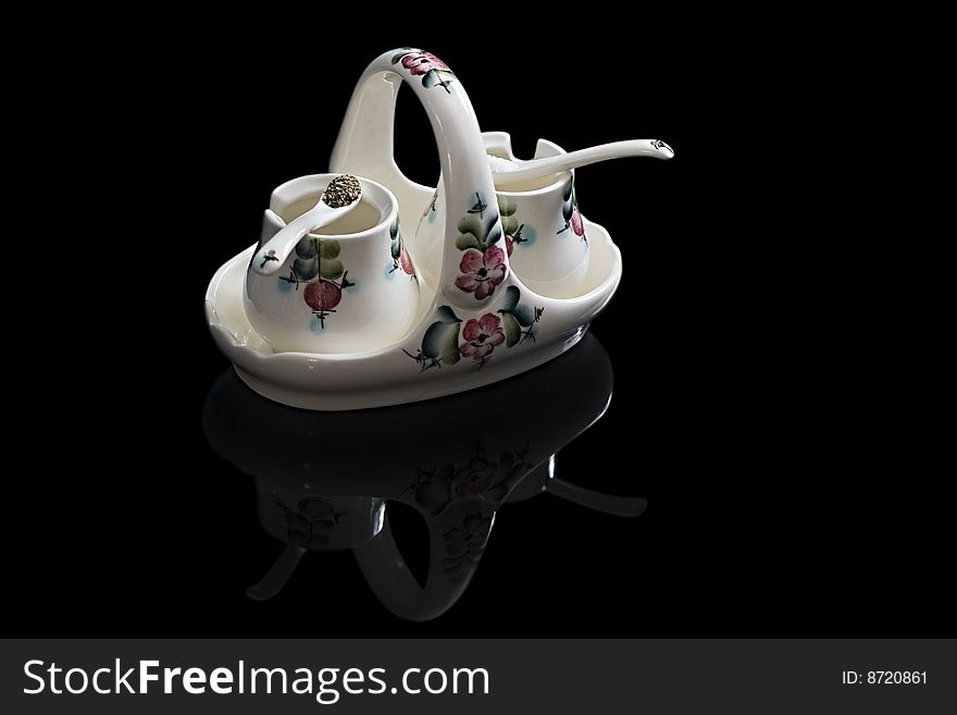 Saltcellar and pepper box in Russian style on a black background. Saltcellar and pepper box in Russian style on a black background