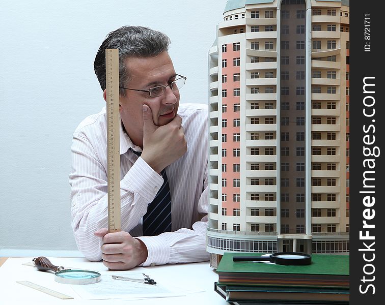 Architect with a breadboard model of a building