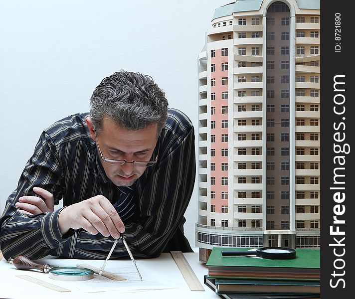 Architect with a breadboard model of a building
