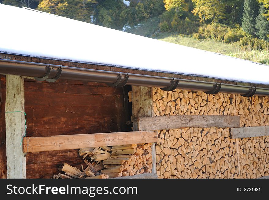 A depot of firewood in an alpine village. A depot of firewood in an alpine village.