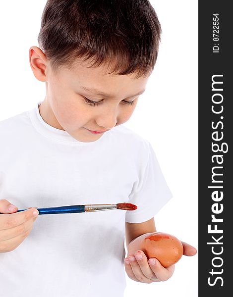 Little boy painting easter egg isolated on white