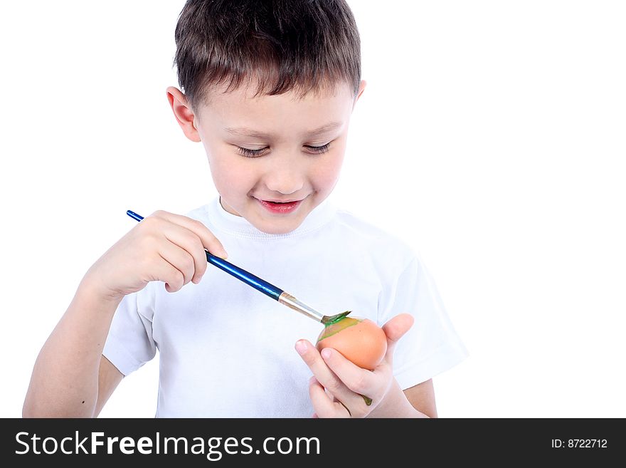 Little boy painting easter egg isolated on white