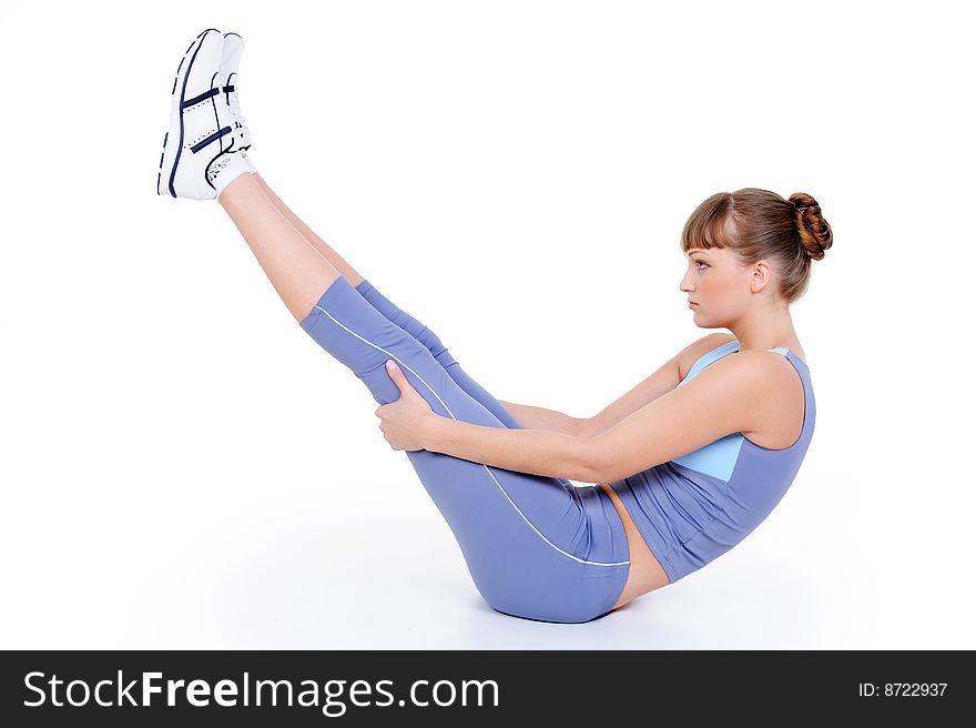 Young girl doing exercise on the floor - on white. Young girl doing exercise on the floor - on white