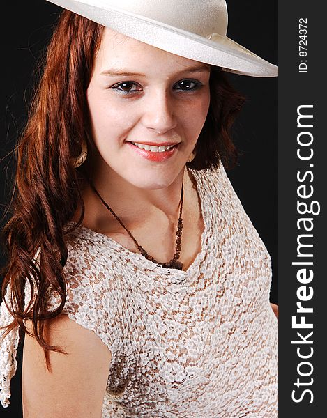 Portrait of a beautiful lady in a beige dress and hat standing in the studio
smiling, for black background. Portrait of a beautiful lady in a beige dress and hat standing in the studio
smiling, for black background.