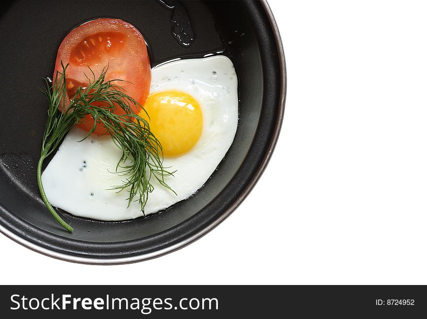 Frying pan with fried egg tomato parsley isolated on white. Frying pan with fried egg tomato parsley isolated on white