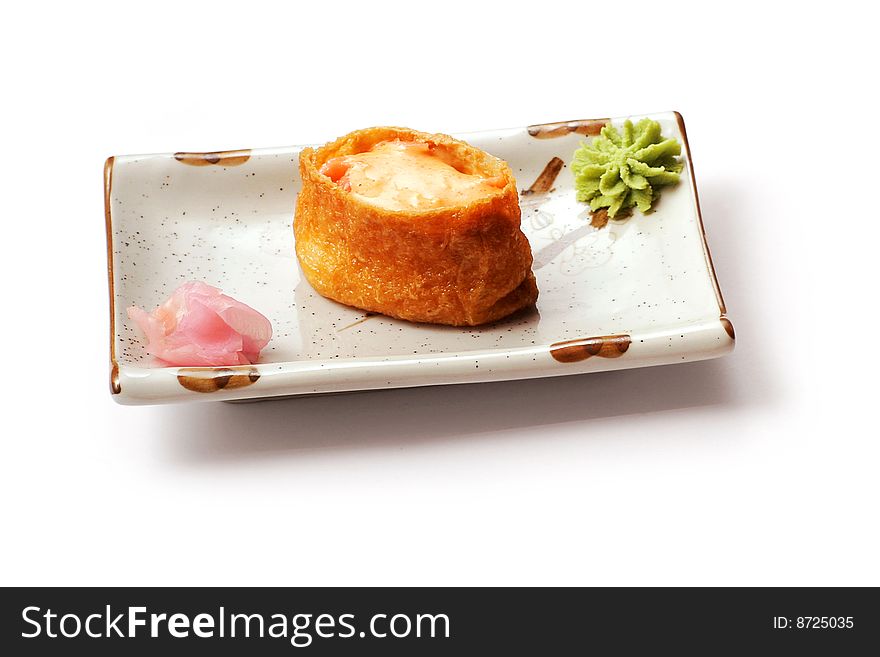 Sushi with salmon, cheese ginger in white squared plate over white background