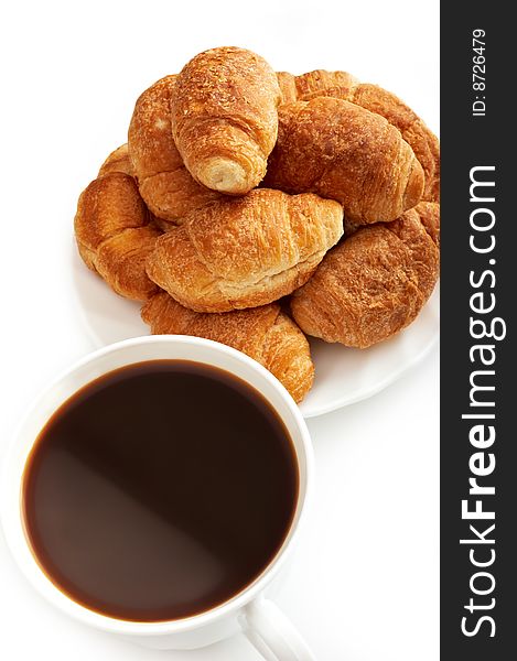 Cup of coffee and croissants on white background