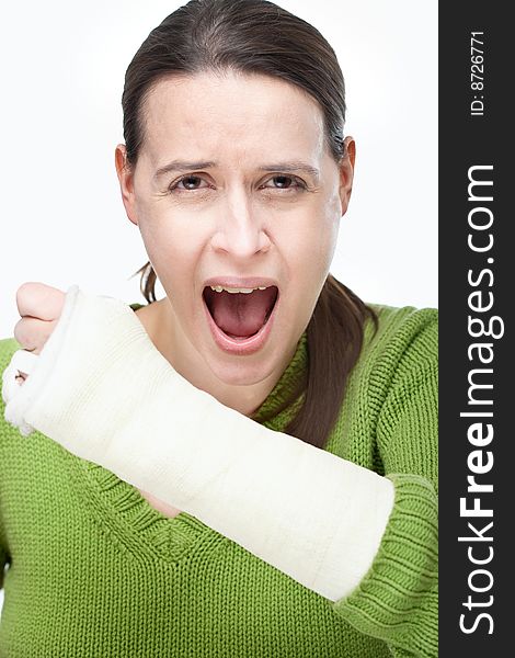 A woman in pain with a broken arm on a white background. A woman in pain with a broken arm on a white background