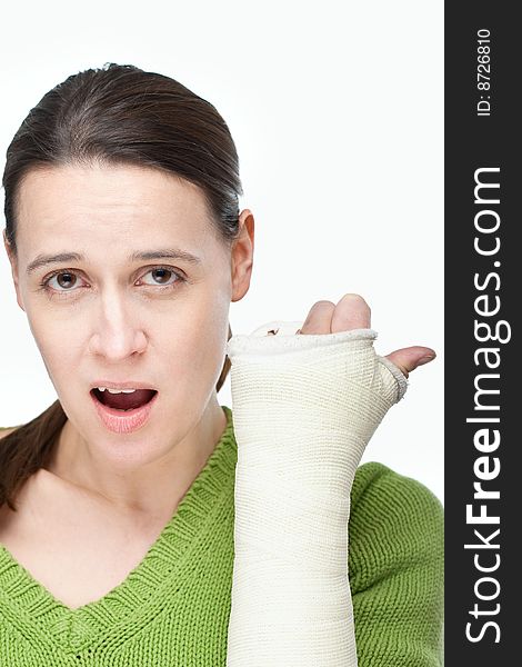 A woman with a cast on her arm on a white background. A woman with a cast on her arm on a white background