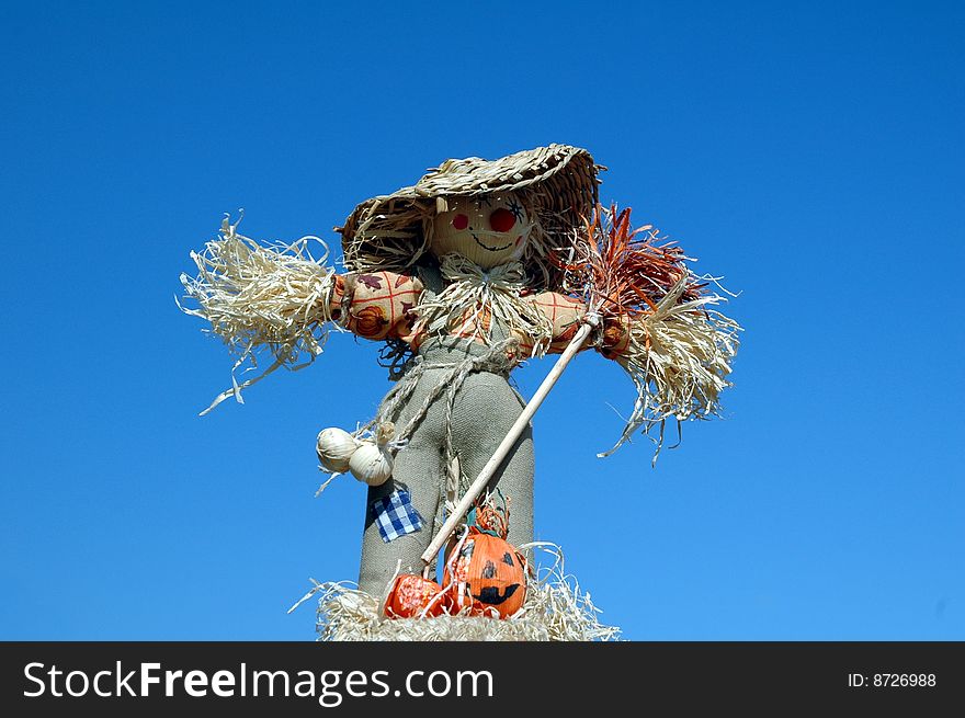 Scarecrow With Broom On Blue