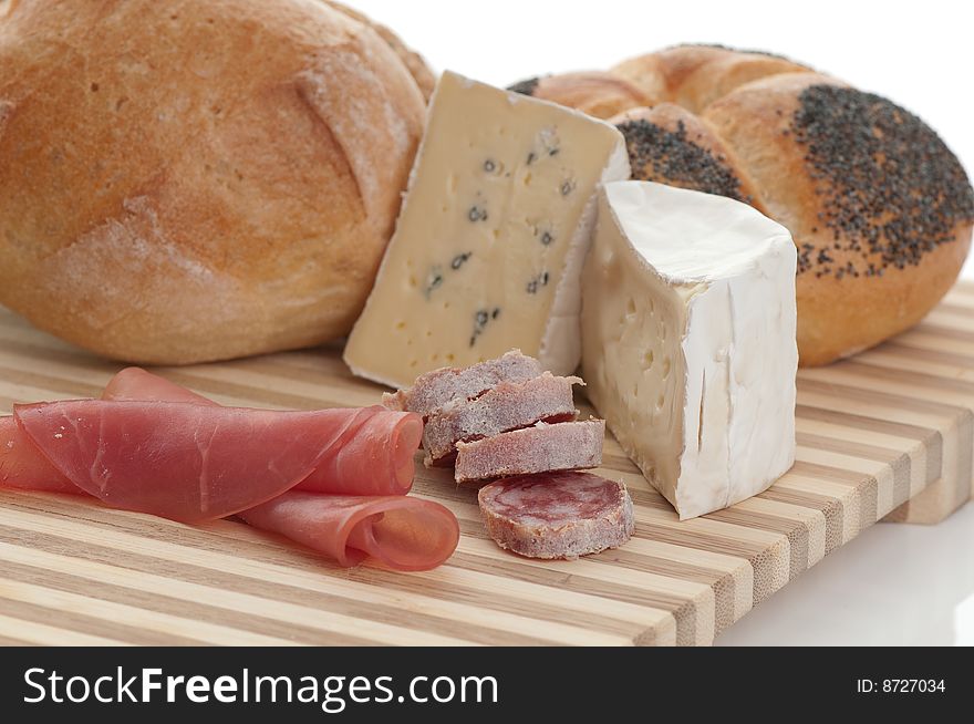 A plate with cheese and bread in front of white