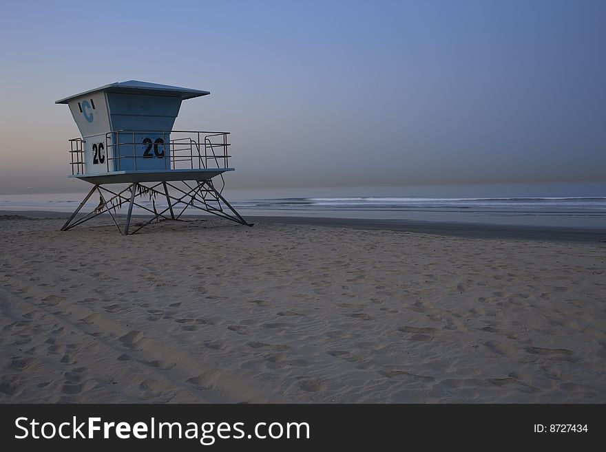 Life guard station on beach with calm ocean at sunrise with moon, San Diego, California. Life guard station on beach with calm ocean at sunrise with moon, San Diego, California