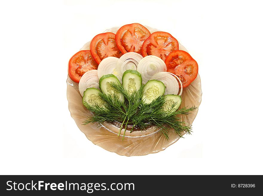 The cut tomatoes, onions and cucumbers on a plate. The cut tomatoes, onions and cucumbers on a plate