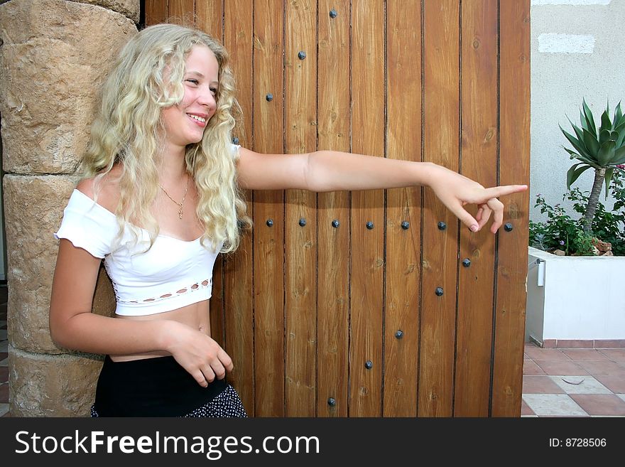 Pretty blond girl showing something with her finger.