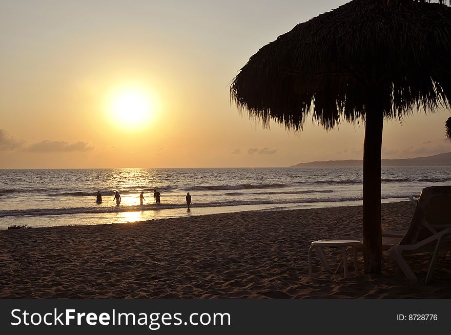 Playing in the surf at sunset on the beach in Mexico