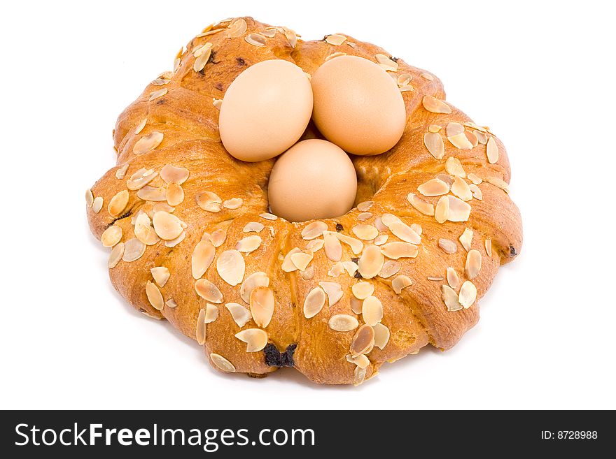 Easter pastry wreath with three brown eggs in it. Easter pastry wreath with three brown eggs in it