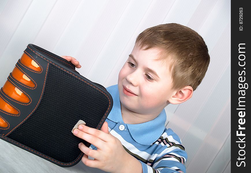 Plastic grey bag for storage DVD of disks in hands of the boy