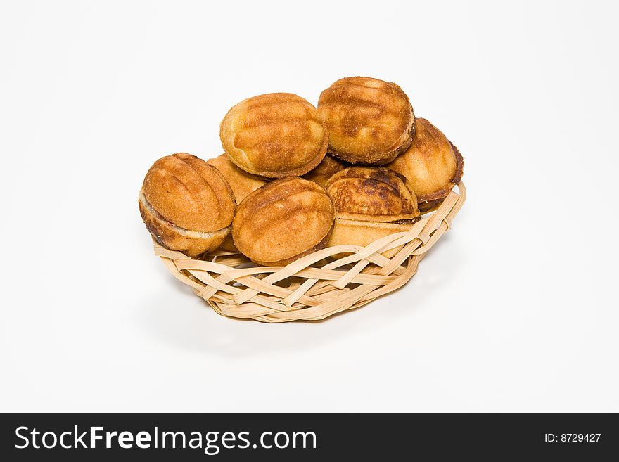 Pastry in a small basket on a white background