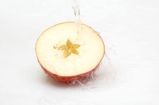 Crystal, Clean Water Splashing On An  Ripe Apple. Royalty Free Stock Photography