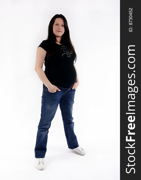 Young pregnant woman with hands in pockets