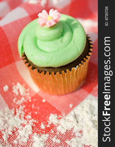 Delicious cupcake on a red table cloth. Delicious cupcake on a red table cloth