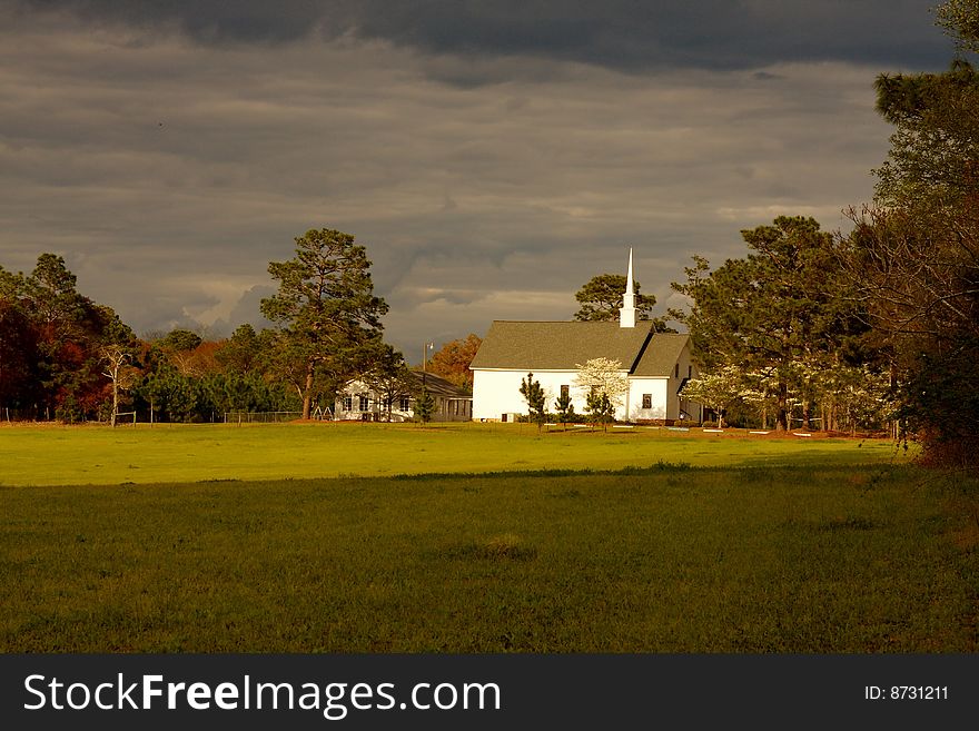 Rural church in a splinter of light following a spring storm. Rural church in a splinter of light following a spring storm