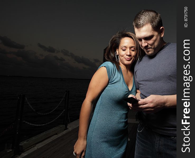 Man and woman looking at a cellphone together. Man and woman looking at a cellphone together