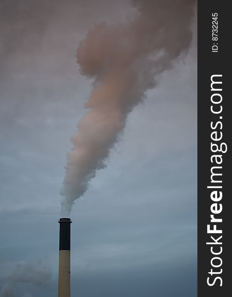 Industrial smokestack emitting pollution into the environment. Industrial smokestack emitting pollution into the environment