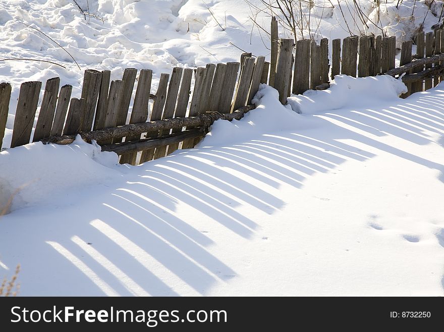 Handrail and shadow  in the snow