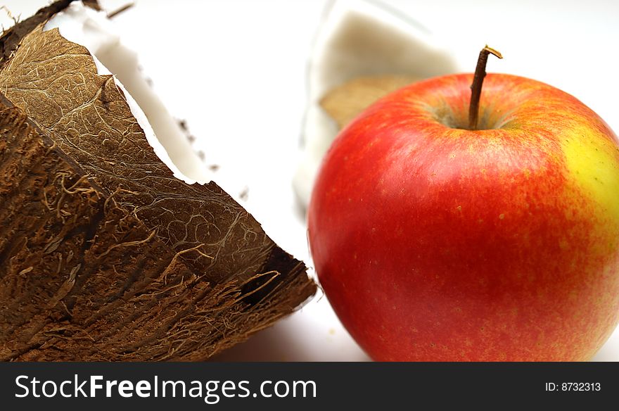 A nice juicy ripe apple. Broken coconut. A nice juicy ripe apple. Broken coconut.