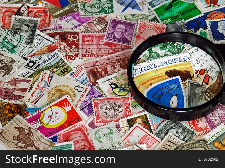 Magnifying glass on vintage stamps. Magnifying glass on vintage stamps.