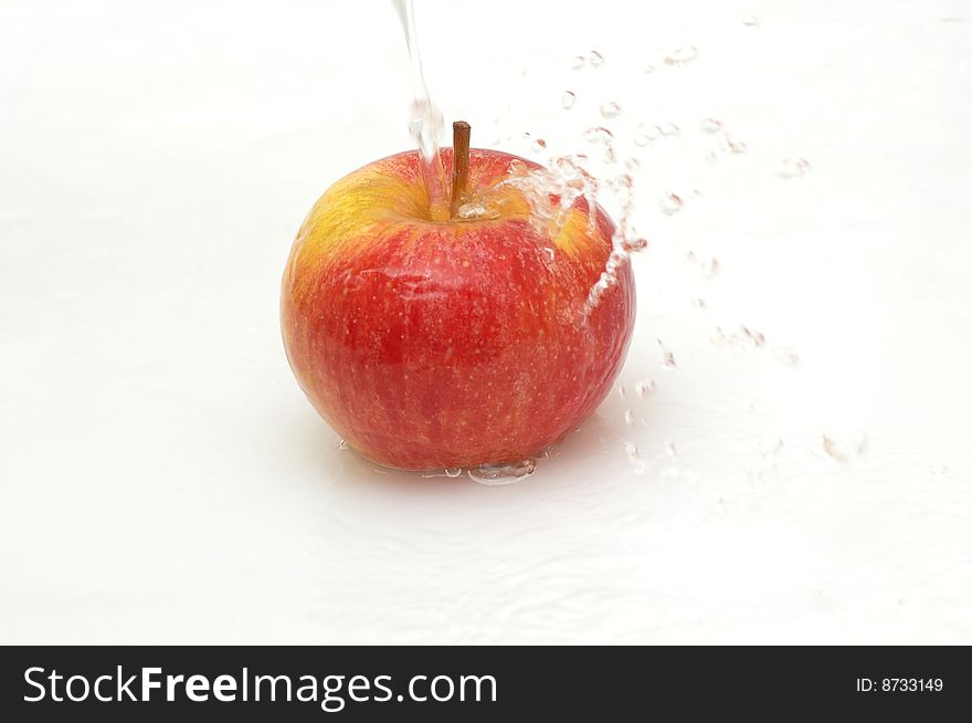 Apple splashing in  cool water.