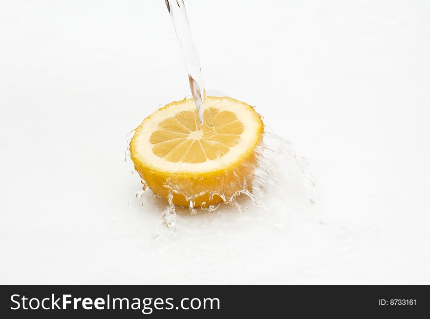 Fresh lemon in streaming water. Fresh lemon in streaming water.