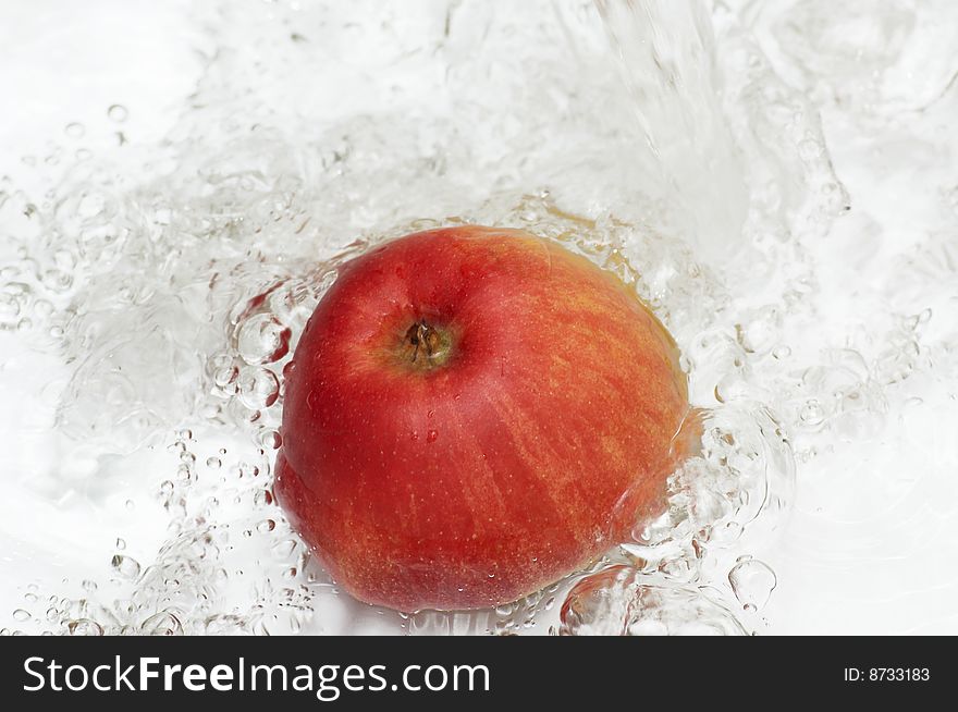 Water splashing on an apple. Water splashing on an apple.