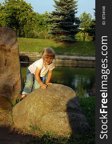 Little girl climb to the top stone. Little girl climb to the top stone