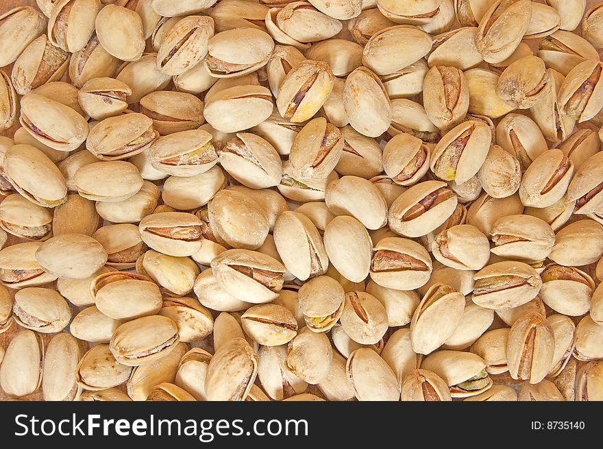 Salty pistachio nuts, food background