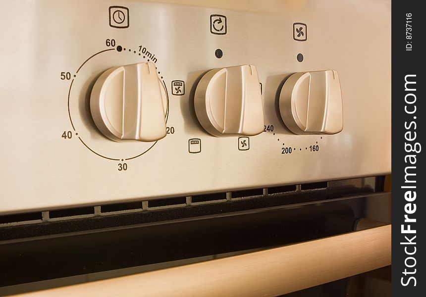 Controls on a modern cooker made of stainless steel. Controls on a modern cooker made of stainless steel