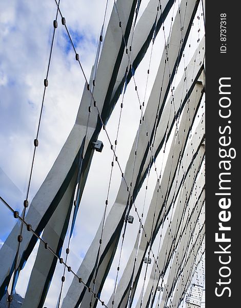 Urban composition with glass, steel, stone and blue sky with clouds that reflected on mirrored building's surface. Urban composition with glass, steel, stone and blue sky with clouds that reflected on mirrored building's surface.